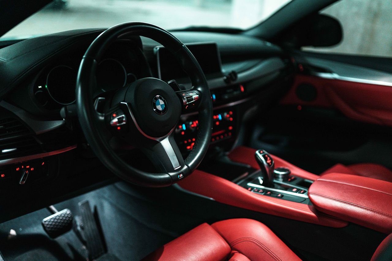 Stunning luxury car interior featuring red leather seats and a modern dashboard design.